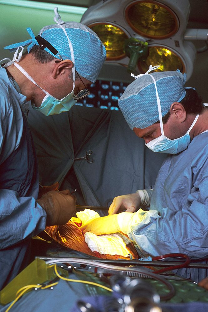 Deux chirurgiens pendant une opération. Archive du National Cancer Institute, juin 1989. Ne documente pas un dossier du cabinet.